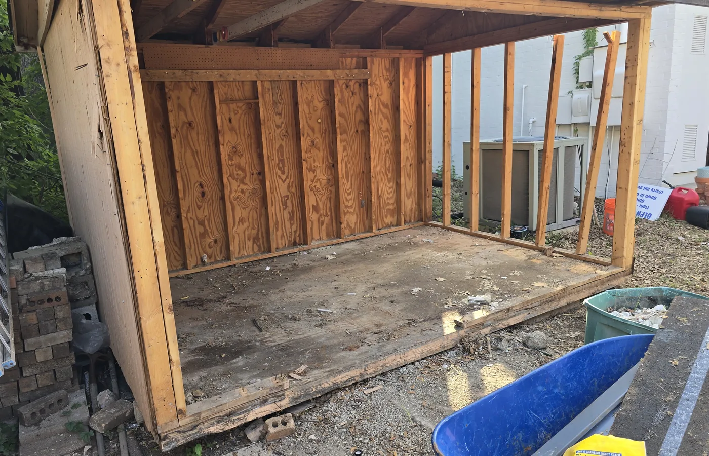 Partially dismantled wooden shed during a small demolition project